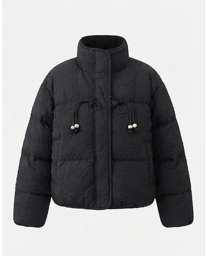 Women's short quilted puffer jacket with high standing collar, textured structure, and decorative drawstrings